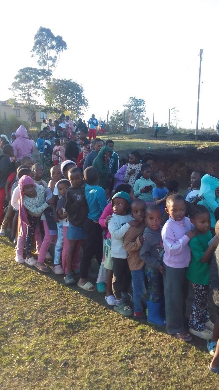Children lining up at an outreach